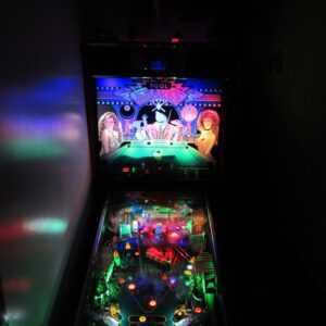 A pinball machine with lights and a video game screen.