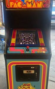 A colorful arcade machine with a maze on the screen.