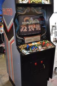 A video game machine with the words double dragon on it.