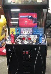 A video game machine with two controllers and a gun.
