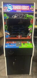 A video game machine with two controllers and a large screen.