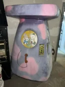 A pink and purple machine with a cartoon on it.