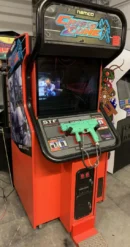 A video game machine with a green gun on it.