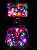 Neon-lit pinball machine with colorful playfield