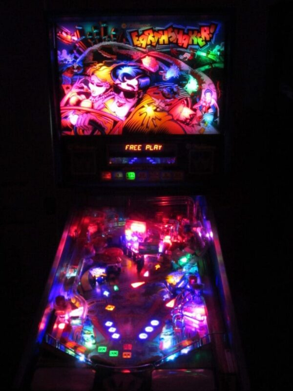 Neon-lit pinball machine with colorful playfield