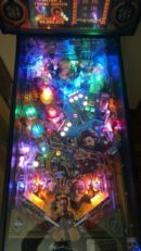 Illuminated colorful pinball machine playfield close-up