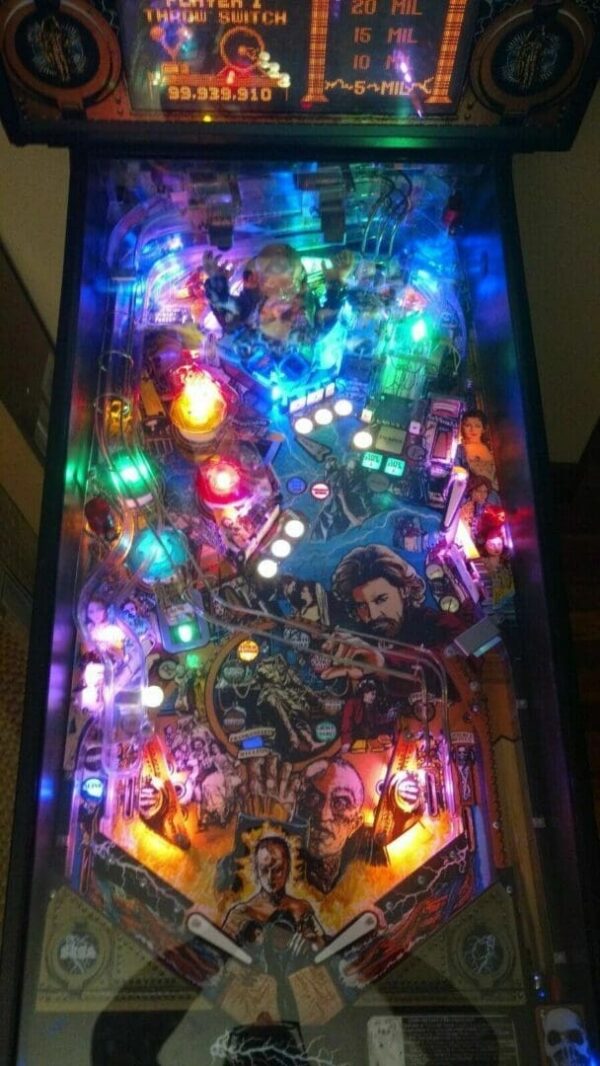 Illuminated colorful pinball machine playfield close-up