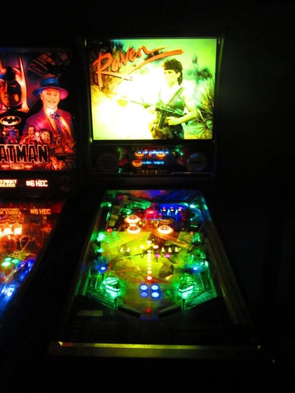 A close up of the pinball machine in the dark.