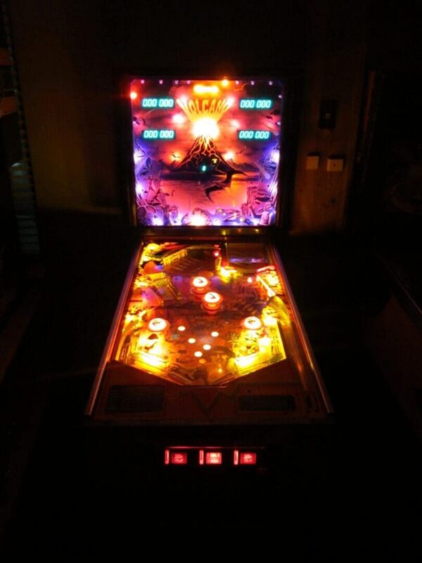 Vintage volcano pinball illuminated in amber