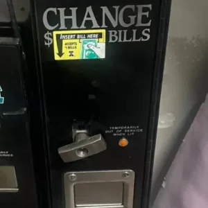A black machine with a sticker on it.