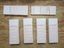 A table with several stacks of paper on it.