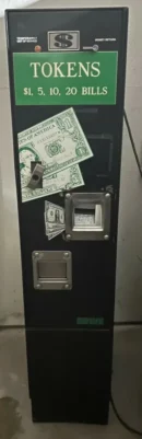 A black machine with money on it.