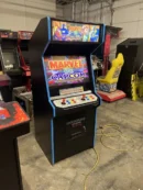 A black arcade machine with blue trim and marvel capcom.
