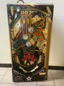 A pinball machine with many different buttons and a large number.