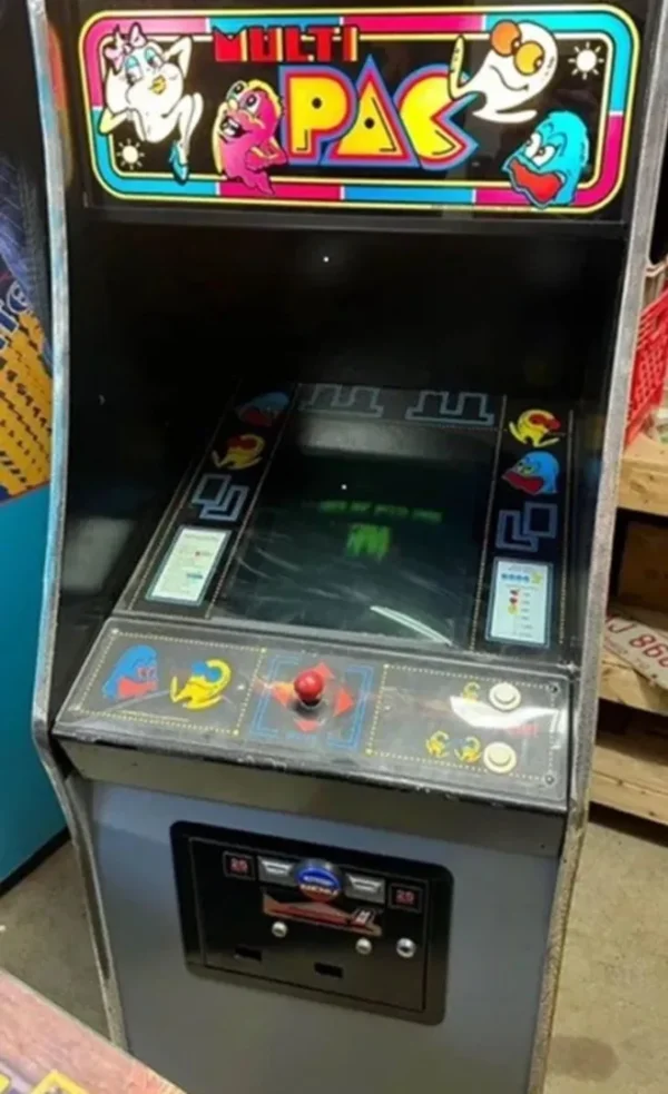A video game machine with many buttons and a large screen.